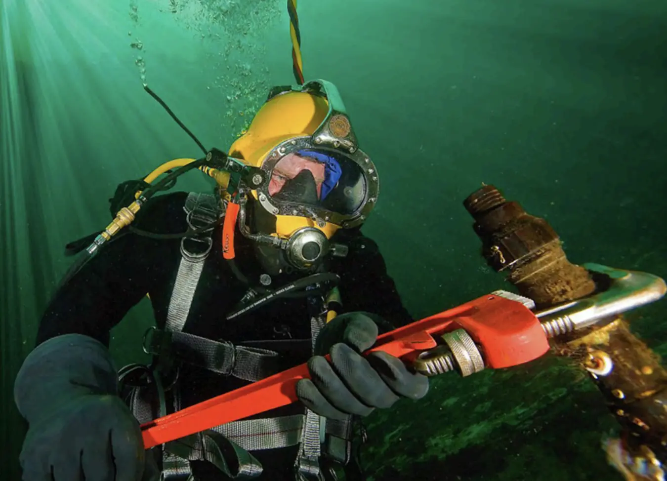 A commercial diver working on underwater equipment