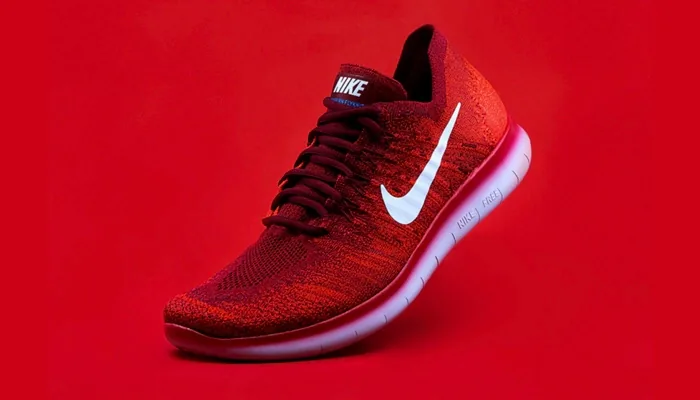 A red trainer photographed against a red background