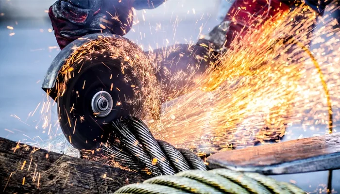 Metalwork being cut with sparks visible